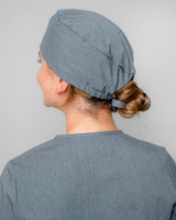 Junge Ärztin mit medizinischer OP Haube in modernem Grau