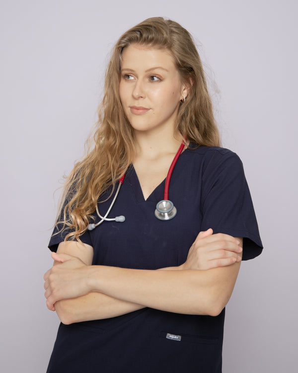 Junge Ärztin mit rotem Stethoskop und modernem Damenkasack in dunkelblau