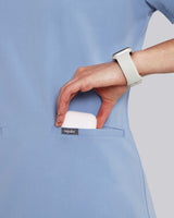Junge Medizinerin mit moderner medizinischer Arbeitskleidung in hellblau mit praktischen Fronttaschen