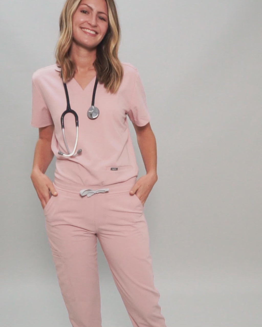 Junge Ärztin mit medizinischer Damenhose in rosa
